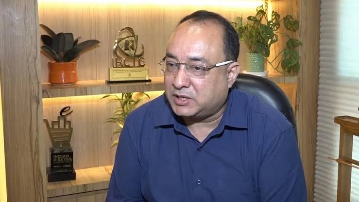 Rahul Himalian in conversation at IRCTC, with corporate awards displayed on the shelving behind him