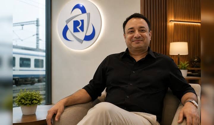 Rahul Himalian seated at IRCTC, with the IRCTC identity behind him and a train visible through the window